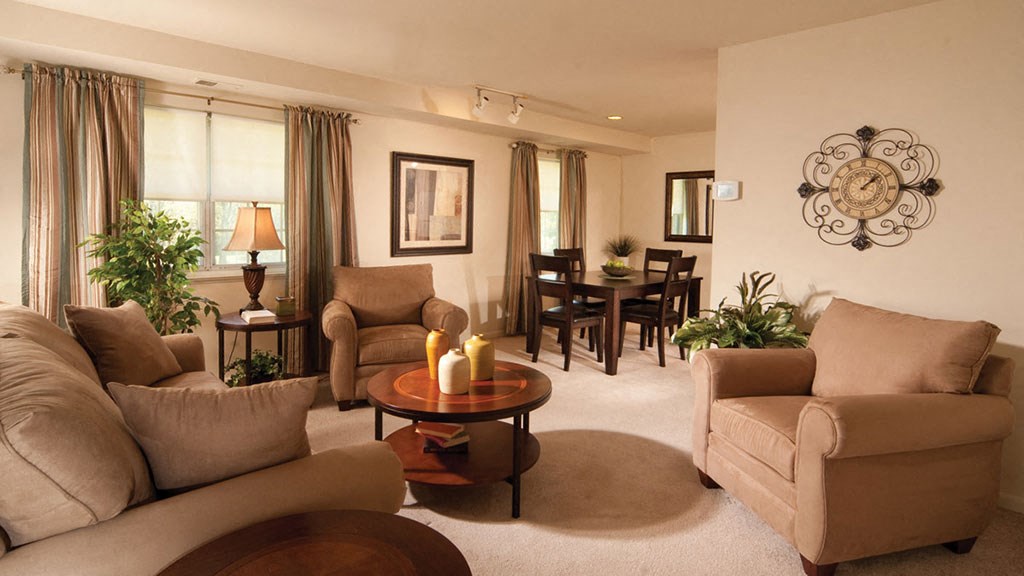 a living room with couches and chairs and a table