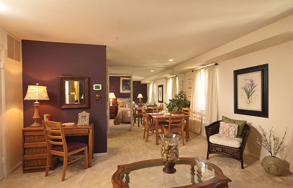 a living room and dining room with a table and chairs