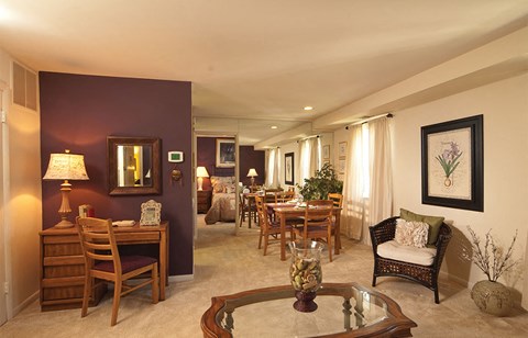 a living room and dining room with a table and chairs