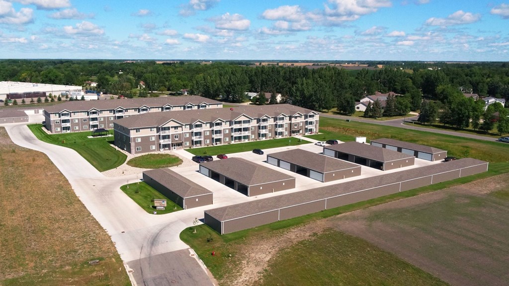 an aerial view of an apartment complex with buildings and a road