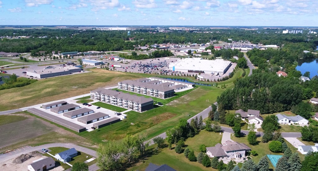 an aerial view of a campus with buildings and a lake