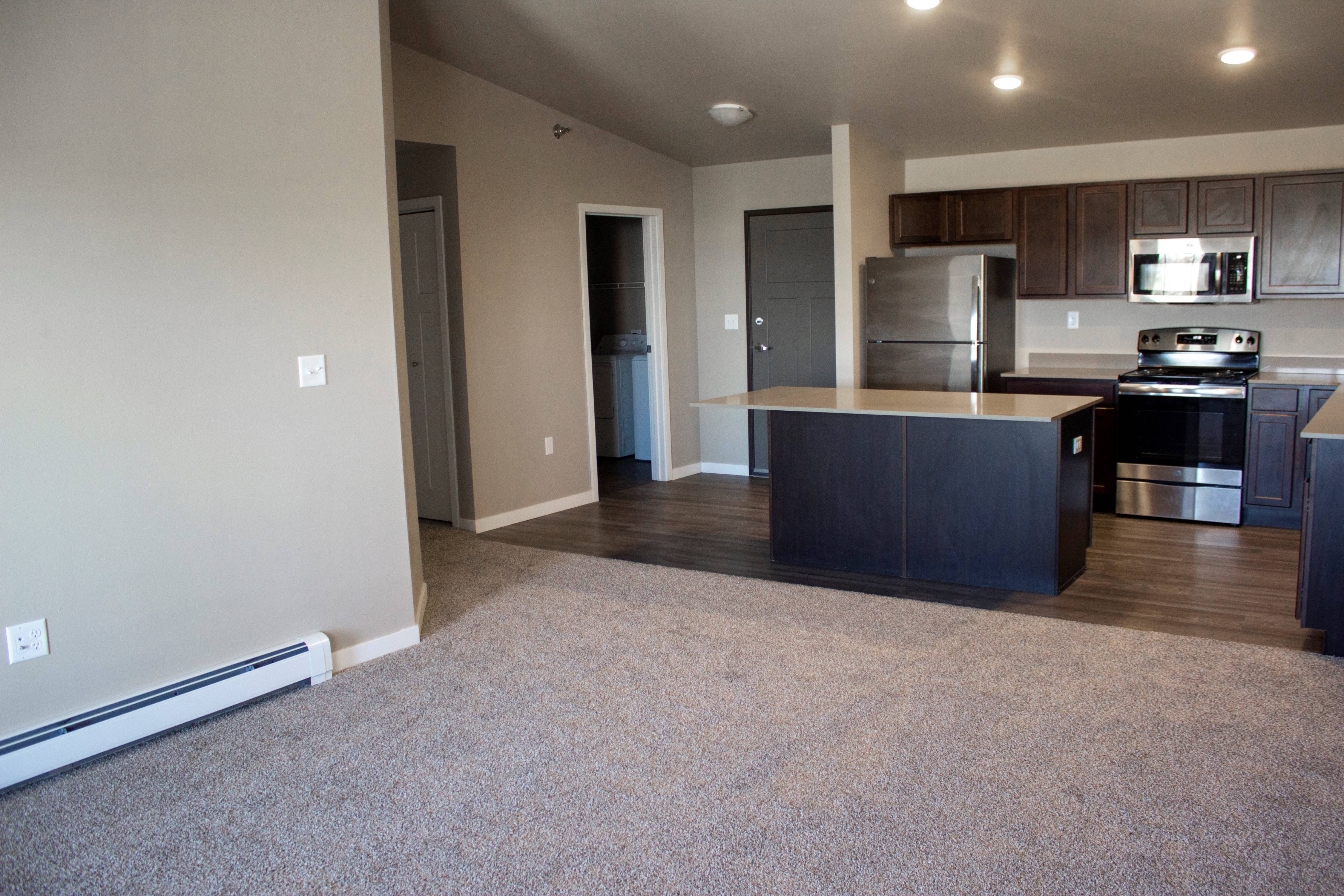 an empty kitchen with an island in the middle