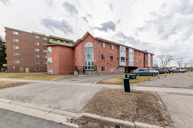 a large brick building with cars parked in front of it