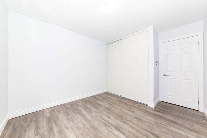 an empty room with white walls and a white door