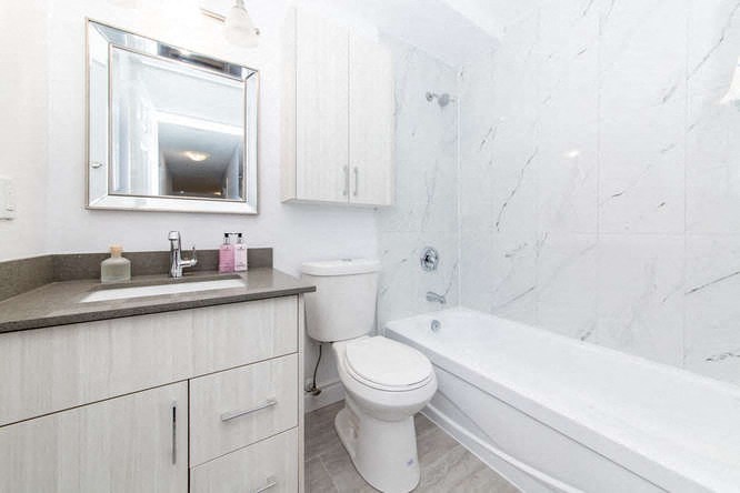 a bathroom with a sink toilet and a bath tub