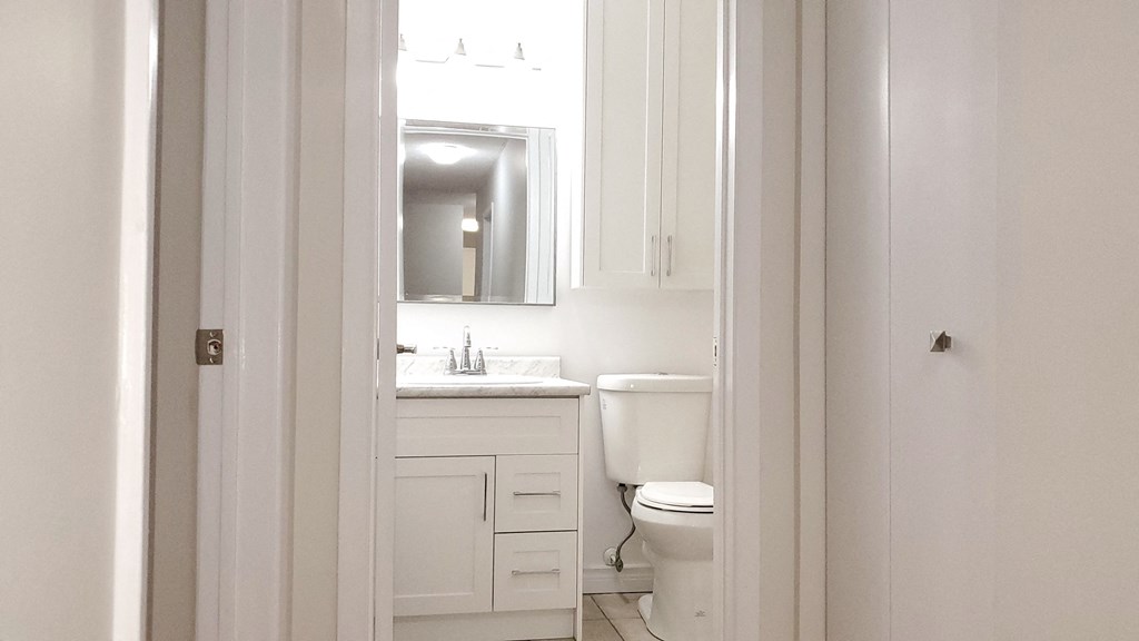 a small white bathroom with a toilet and a sink