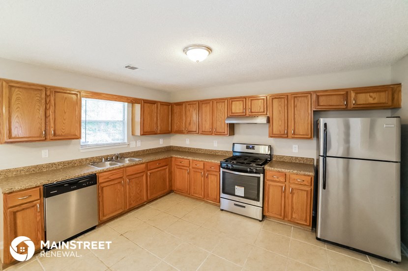 a kitchen with wooden cabinets and stainless steel appliances