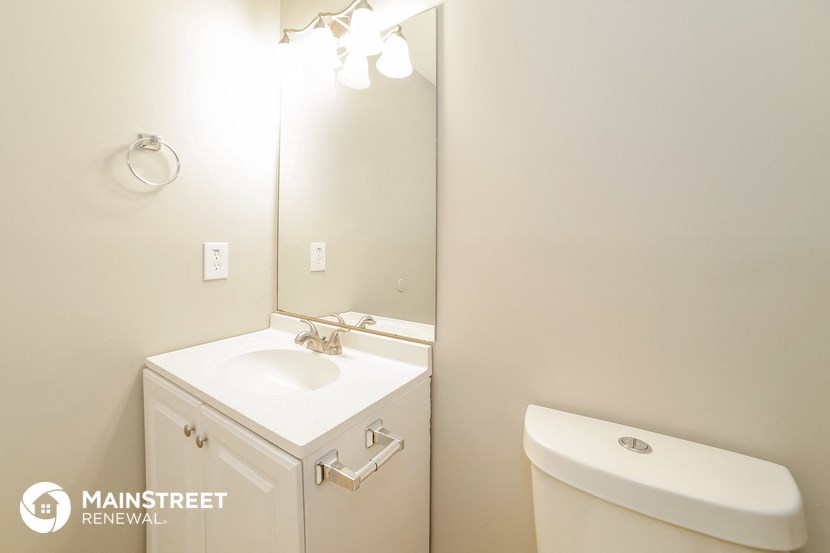 a bathroom with a sink and a mirror and a toilet