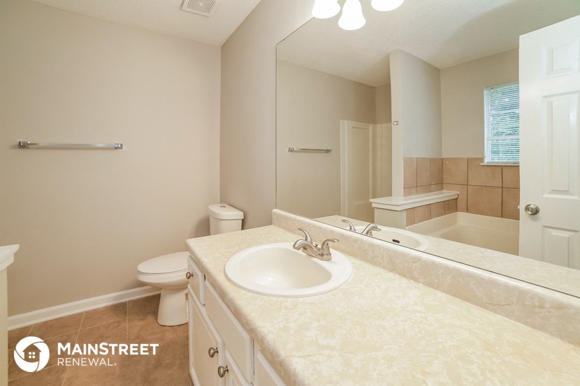 a bathroom with a sink and a toilet and a mirror