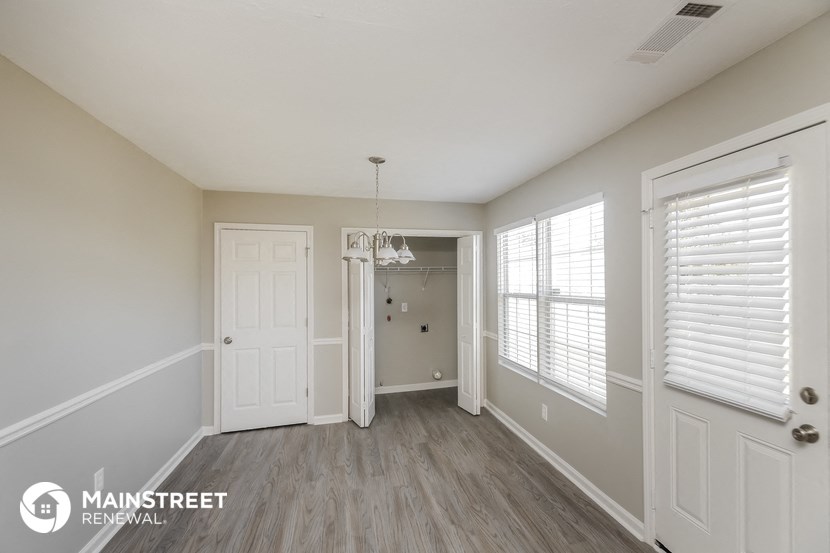 the living room of a new home with white walls and wood flooring