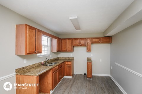 a kitchen with wood cabinets and granite counter tops and a sink