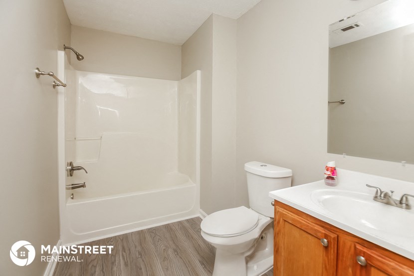 a bathroom with a shower toilet and sink and a mirror