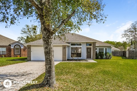 a house with a tree in the front yard