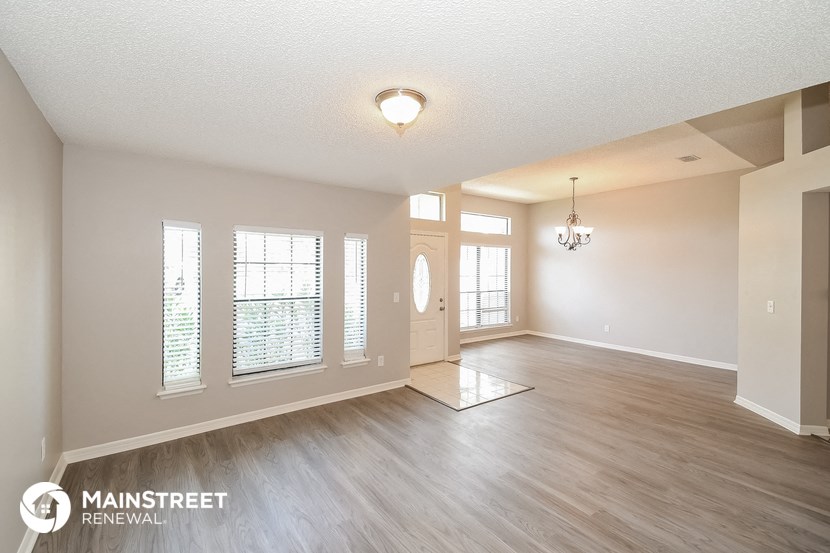 the living room and dining room of an open floor plan