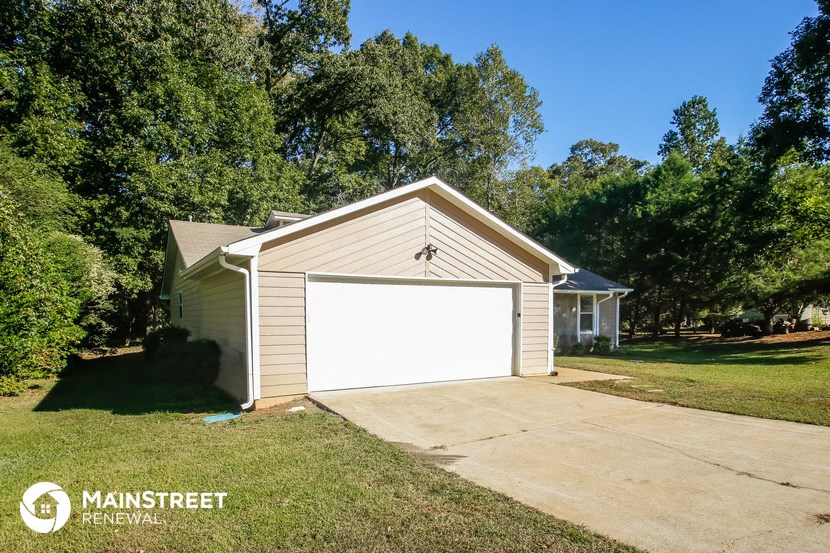 a garage with a white garage door on the side of a house