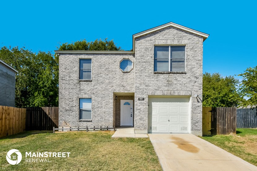 a white brick house with a white garage door