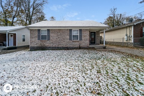 a brick house with snow on the ground