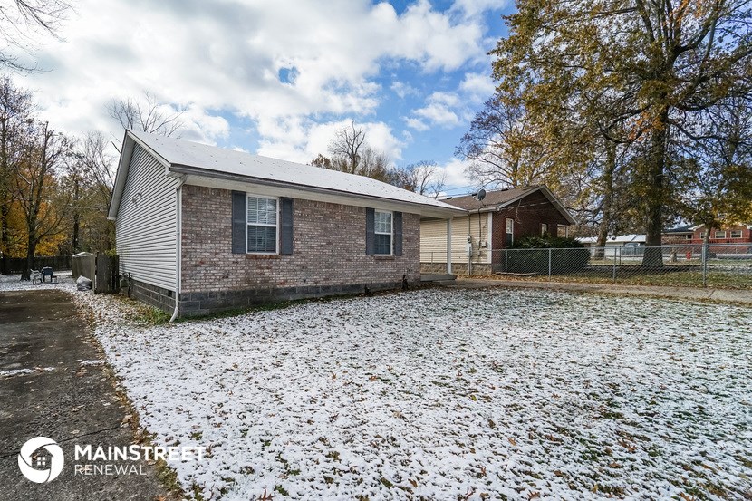 a brick house with snow on the ground
