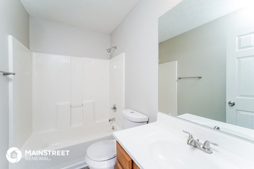 a bathroom with a sink and a toilet and a mirror