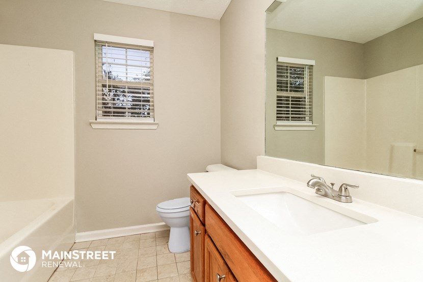 a bathroom with a sink and a toilet and a mirror
