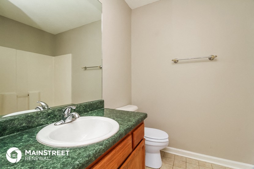 a bathroom with a sink and toilet and a mirror