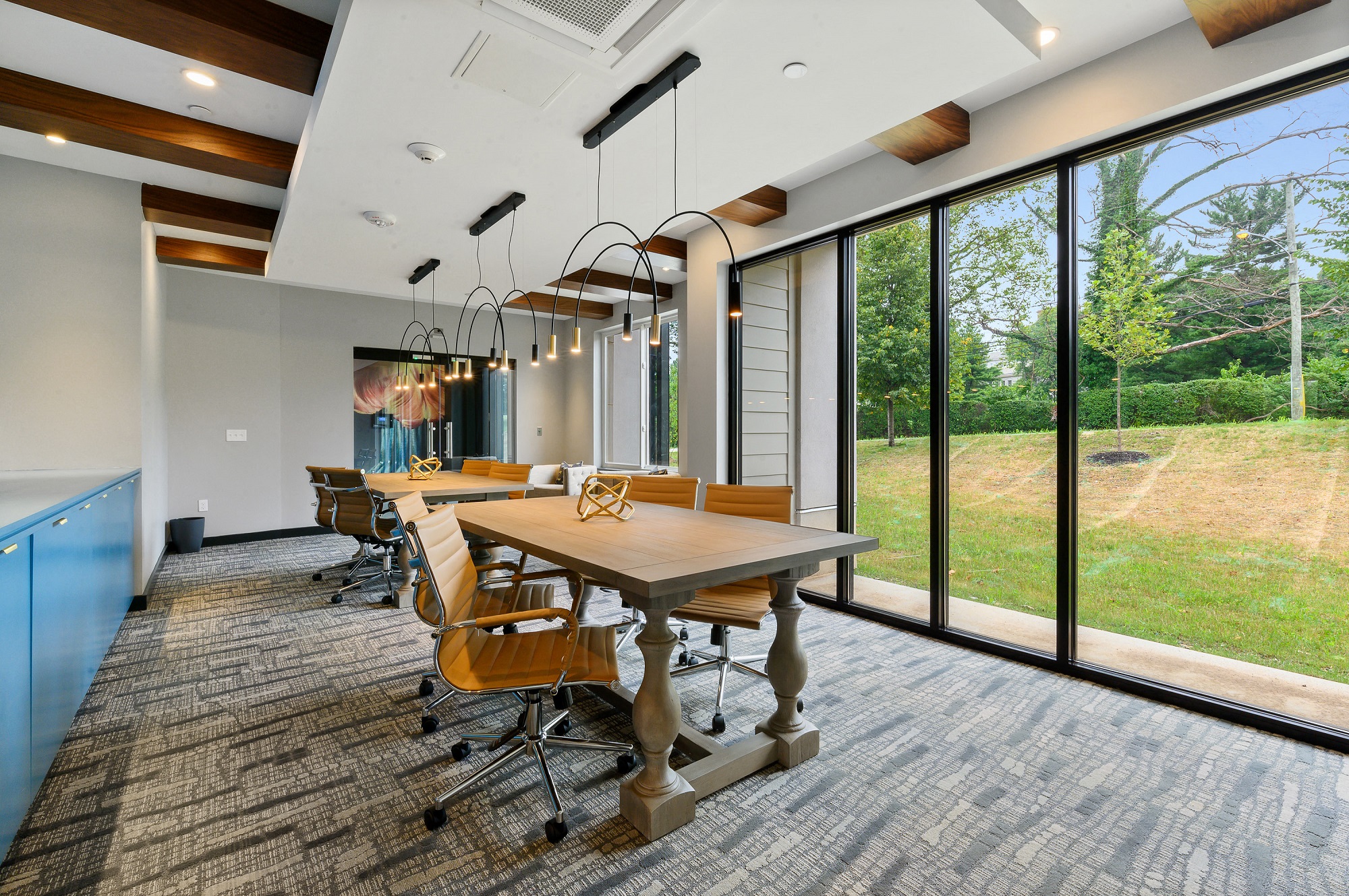 Work from home space with tables, chairs, and beautiful overhead lighting
