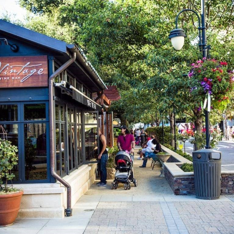 a street scene with people and a baby stroller