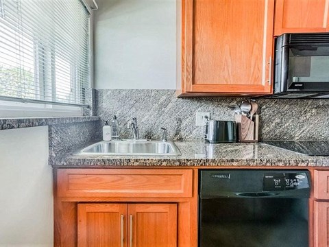 a kitchen with a sink and a microwave