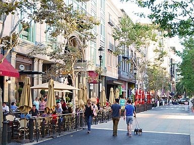 a group of people walking down a city street