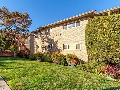 a brick house with a lawn in front of it