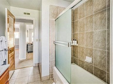 a bathroom with a shower and a bath tub