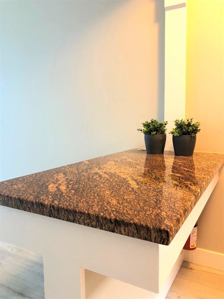 a marble countertop with two potted plants on it
