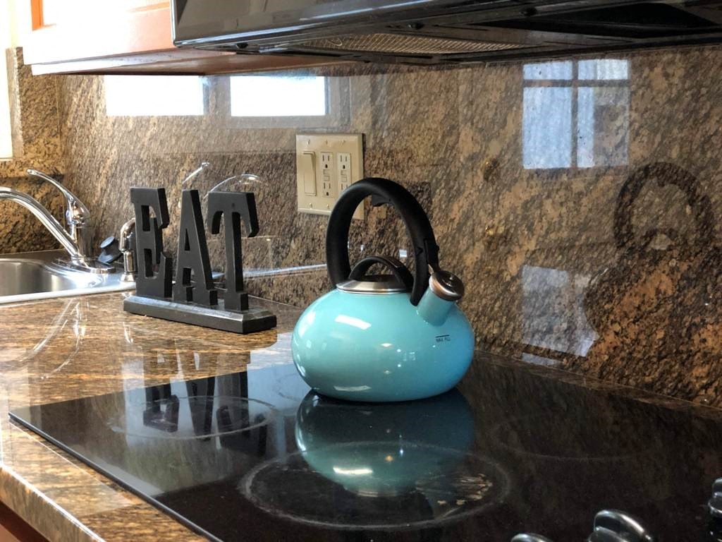 a turquoise kettle on a kitchen counter top