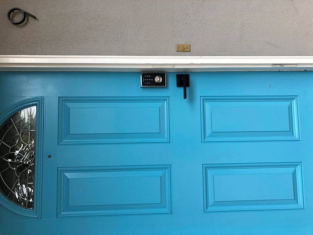 a blue garage door with a window on it