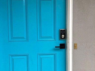 a blue door with a black door handle