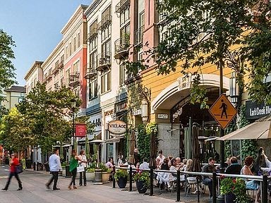 a group of people walking down a city street