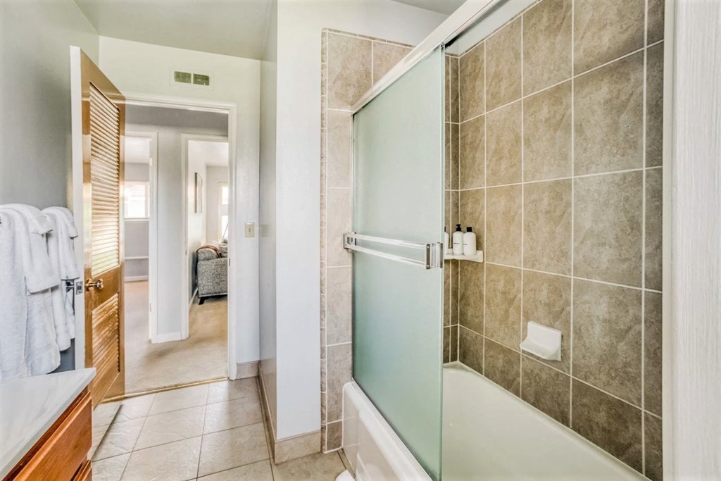 a bathroom with a shower with a glass door