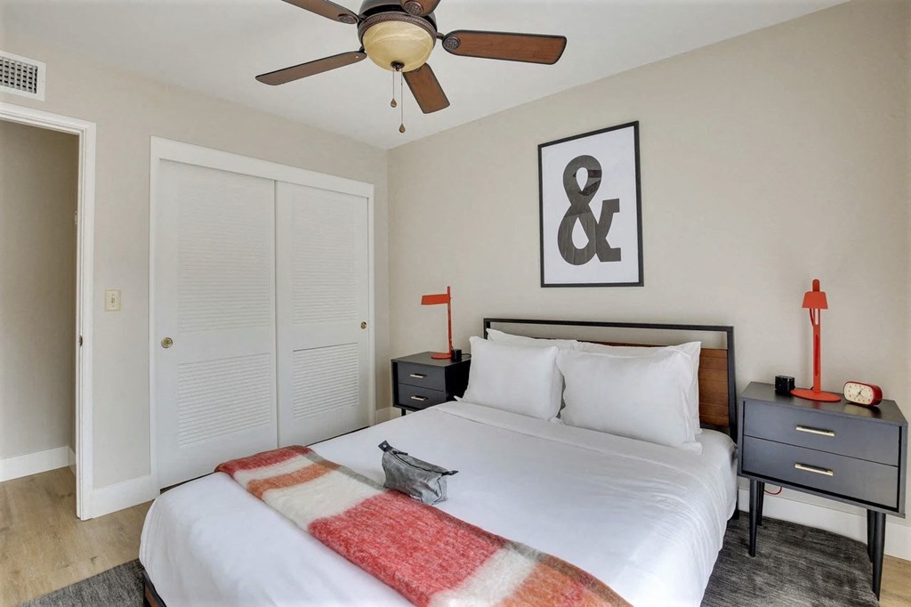 a bedroom with a bed and a ceiling fan