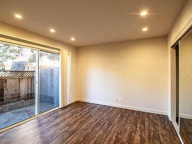an empty living room with a sliding glass door