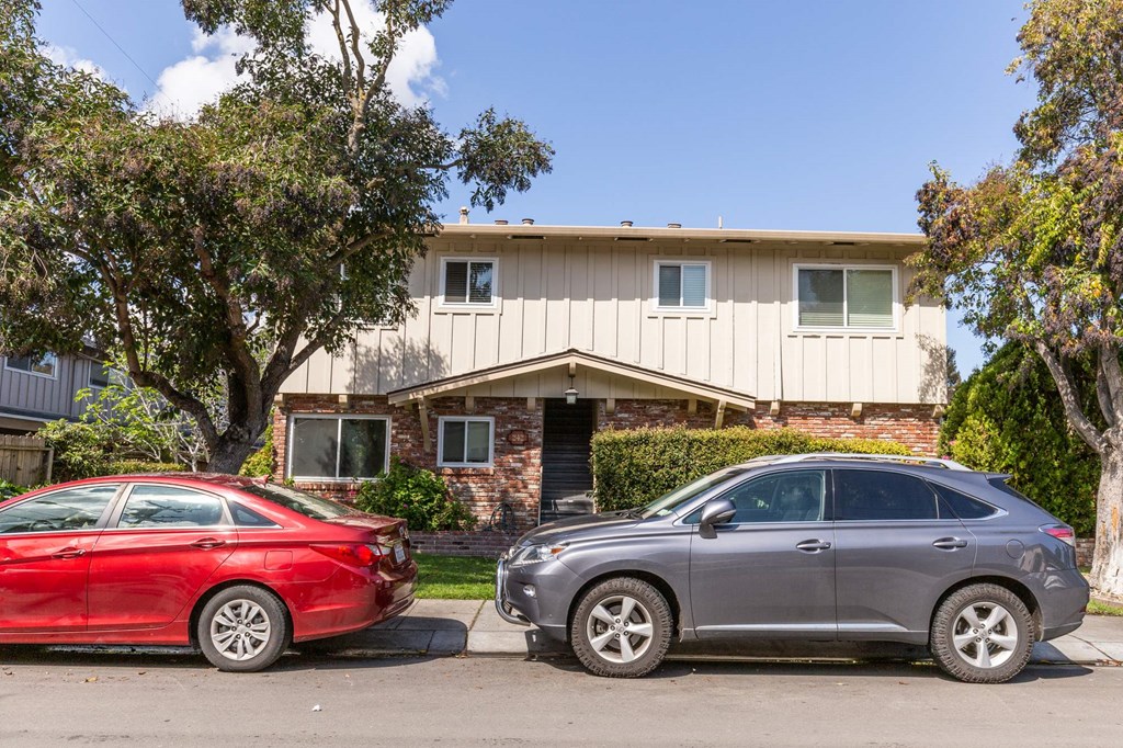 two cars parked in front of a house