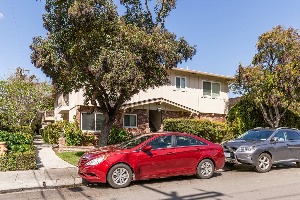 two cars parked in front of a house