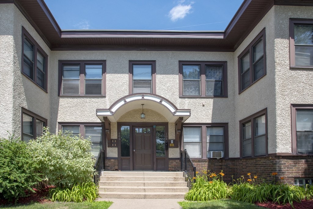 the front of a building with steps and a door