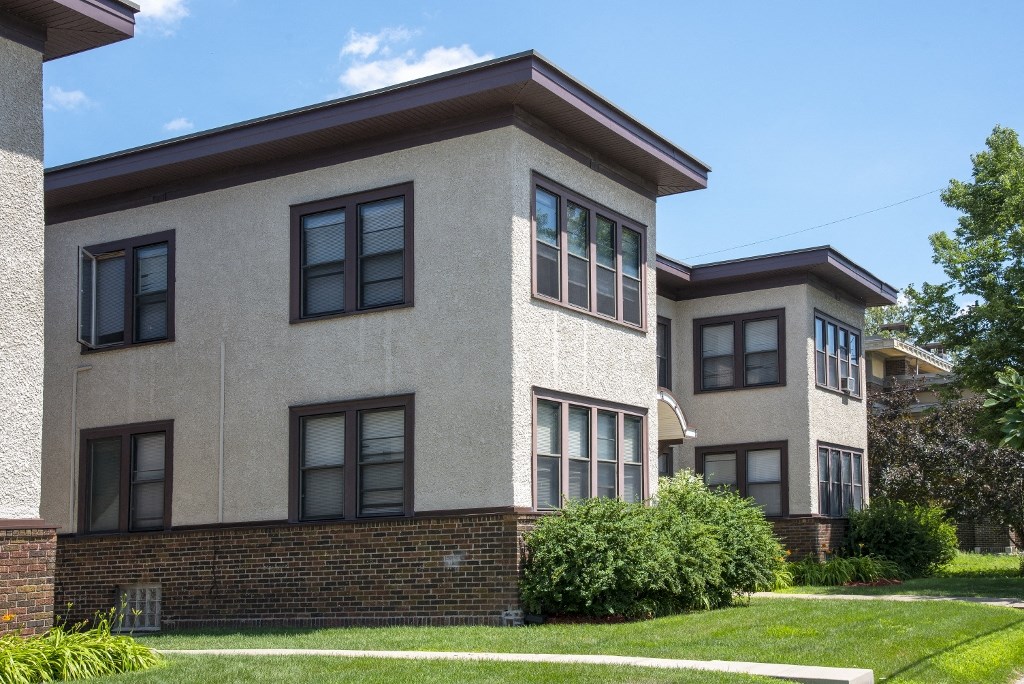 a view of the exterior of two buildings on a sunny day