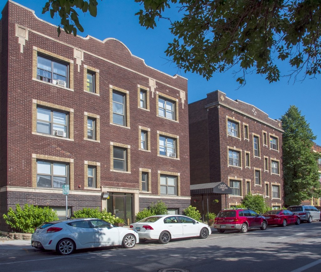 a large brick building with cars parked in front of it