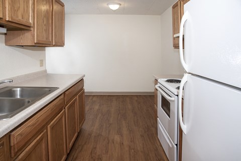 the preserve at ballantyne commons apartment kitchen with white appliances and wooden cabinets
