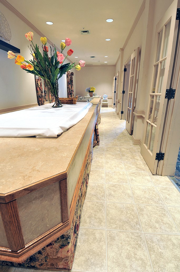 a long counter with a vase of flowers on it