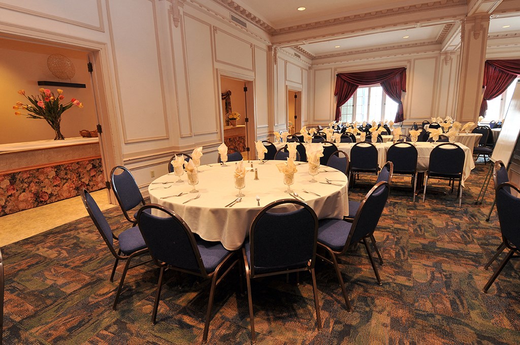 a dining room with tables and chairs in a conference room