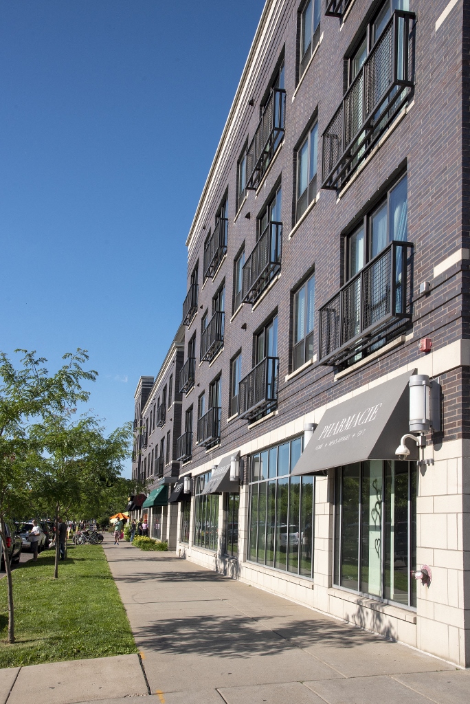 a large brick building with a sidewalk in front of it