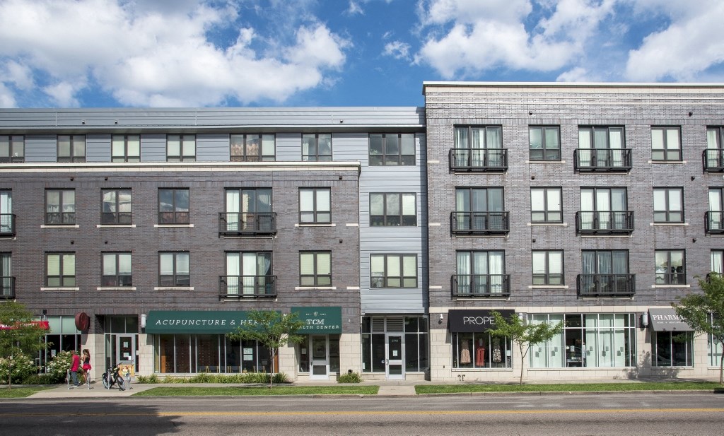 an apartment building on the corner of a city street