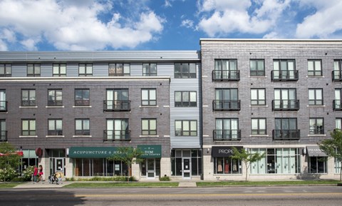 an apartment building on the corner of a city street